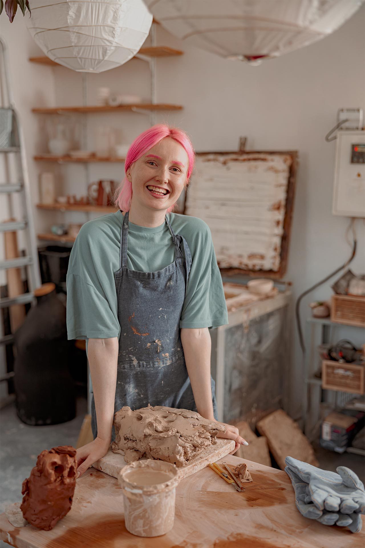 cheerful-craftswoman-standing-at-her-pottery-works-2022-02-14-16-30-26-utc.jpg