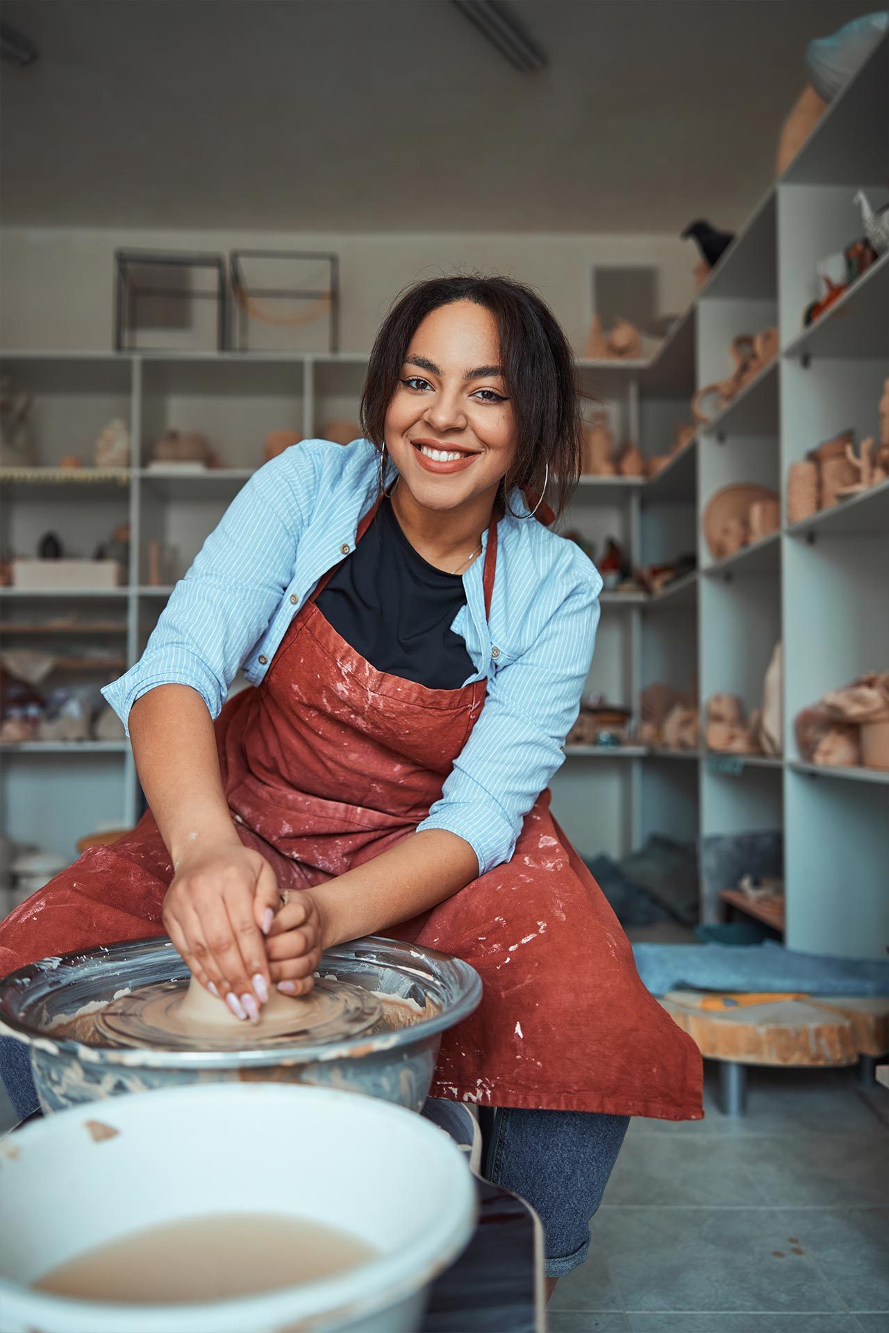 cheerful-female-ceramist-making-pottery-in-worksho-2021-09-04-14-23-50-utc.jpg